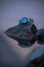 ARES Alpine FIELD-1 timer watch on a rock with a reflective surface