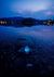 Reflective water surface with a watch at night